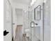 Elegant bathroom with modern fixtures, marble tile, walk-in shower, and stylish pedestal sink at 245 W George Ave, Maitland, FL 32751
