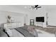 A Primary bedroom with modern gray decor, including gray floors, a ceiling fan, and updated lighting at 245 W George Ave, Maitland, FL 32751
