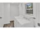 Functional laundry room with side-by-side washer and dryer beneath a window at 245 W George Ave, Maitland, FL 32751