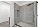 Modern shower with gray tile, a glass door, and updated fixtures in a bright and airy bathroom at 245 W George Ave, Maitland, FL 32751