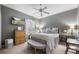 Comfortable bedroom features a ceiling fan, a television, and ample natural light from the window at 4040 Palma Ceia Cir, Winter Haven, FL 33884