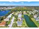 An aerial showcasing a community of homes near a tranquil lake at 103 Old Sunbeam Dr, South Daytona, FL 32119