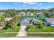 Single-Gathering home on a canal with lush landscaping and a two-car garage at 103 Old Sunbeam Dr, South Daytona, FL 32119