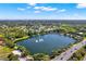 Wide aerial view of a lake with fountain and surrounding neighborhood at 103 Old Sunbeam Dr, South Daytona, FL 32119