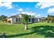 Spacious backyard with lush lawn and screened patio at 103 Old Sunbeam Dr, South Daytona, FL 32119