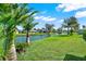 Spacious backyard with pond view and tropical landscaping at 103 Old Sunbeam Dr, South Daytona, FL 32119