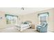 Bright bedroom with comfortable bed and sitting area at 103 Old Sunbeam Dr, South Daytona, FL 32119
