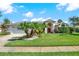 Home's front exterior showcasing a white garage door and lush lawn at 103 Old Sunbeam Dr, South Daytona, FL 32119