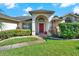 House exterior featuring a red door, landscaping, and walkway at 103 Old Sunbeam Dr, South Daytona, FL 32119