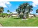 Landscaped yard with palm trees and house exterior at 103 Old Sunbeam Dr, South Daytona, FL 32119