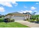 White double car garage with landscaping at 103 Old Sunbeam Dr, South Daytona, FL 32119