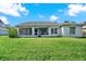 House exterior showcasing a screened porch and lawn at 103 Old Sunbeam Dr, South Daytona, FL 32119