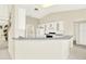 Bright kitchen features white cabinets, gray countertops, and a breakfast bar at 103 Old Sunbeam Dr, South Daytona, FL 32119