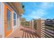 Spacious balcony featuring wooden flooring, metal railings, and an orange door at 14046 Walcott Ave, Orlando, FL 32827