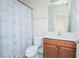 Cozy bathroom featuring a shower with a patterned curtain and a wooden vanity cabinet at 14046 Walcott Ave, Orlando, FL 32827
