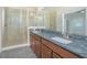 Bathroom with granite counters, and sinks, a glass shower, and tiled floors at 14046 Walcott Ave, Orlando, FL 32827
