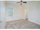 Comfortable bedroom with neutral carpet, large window, and doorway to a walk-in closet at 14046 Walcott Ave, Orlando, FL 32827