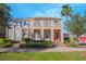 Charming two-story home with manicured landscaping, a well-kept lawn, and a welcoming entrance at 14046 Walcott Ave, Orlando, FL 32827