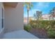 Manicured side yard with lush hedges, mulch, and a palm tree adding to the curb appeal at 14046 Walcott Ave, Orlando, FL 32827