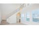 Modern staircase with metal railings and large windows offering natural light at 14046 Walcott Ave, Orlando, FL 32827