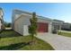 Attached garage with a reddish-orange door and a paved driveway at 434 Belmond Dr, Debary, FL 32713