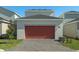 Attached garage with a reddish-orange door and a paved driveway at 434 Belmond Dr, Debary, FL 32713