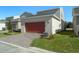 Attached garage with a reddish-orange door and a paved driveway at 434 Belmond Dr, Debary, FL 32713