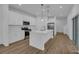 Modern kitchen boasting white cabinets, quartz countertops, and stainless steel appliances at 434 Belmond Dr, Debary, FL 32713
