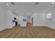 Open living room with kitchen, hardwood floors, and island at 434 Belmond Dr, Debary, FL 32713