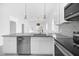 Kitchen island featuring a gray countertop, stainless steel dishwasher, and eat-in bar at 600 N Lakewood Ave, Ocoee, FL 34761