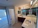 Double vanity bathroom with a large mirror and separate shower at 10065 Lake District Ln, Orlando, FL 32832