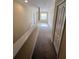 Upstairs hallway with carpet, window, and doors at 10065 Lake District Ln, Orlando, FL 32832