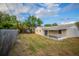 Large backyard with wooden fence and covered patio at 4533 San Sebastian Cir, Orlando, FL 32808