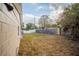 Side yard with a view of a wooden fence and grassy area at 4533 San Sebastian Cir, Orlando, FL 32808