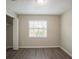 Well-lit bedroom with wood-look floors and window blinds at 4533 San Sebastian Cir, Orlando, FL 32808