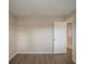Simple bedroom with wood-look floors and a door to a bathroom at 4533 San Sebastian Cir, Orlando, FL 32808