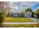 Newly renovated single story home with red door and spacious lawn at 4533 San Sebastian Cir, Orlando, FL 32808