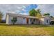 Newly renovated home with stone accents and a well-maintained lawn at 4533 San Sebastian Cir, Orlando, FL 32808
