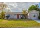 Ranch-style house with stone accents and a red front door at 4533 San Sebastian Cir, Orlando, FL 32808