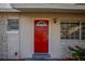 Red front door with a stone facade at 4533 San Sebastian Cir, Orlando, FL 32808