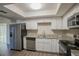 Modern kitchen with white cabinets, granite counters, and stainless steel appliances at 4533 San Sebastian Cir, Orlando, FL 32808