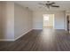 Spacious living room with dark gray vinyl flooring and ceiling fan at 4533 San Sebastian Cir, Orlando, FL 32808