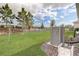 Well-maintained backyard featuring a lush lawn, fenced perimeter, and mature landscaping at 7889 Penrose Pl, Wildwood, FL 34785