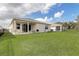 Picture of back exterior showing the spacious backyard, fence, and patio at 7889 Penrose Pl, Wildwood, FL 34785