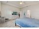 Bedroom featuring neutral colors, tray ceiling and an ensuite bath at 7889 Penrose Pl, Wildwood, FL 34785