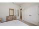 Bedroom with a decorative mirror atop dresser and double door closet at 7889 Penrose Pl, Wildwood, FL 34785