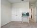 Bedroom featuring neutral carpet, double door closet and television at 7889 Penrose Pl, Wildwood, FL 34785
