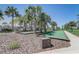 Bocce ball court featuring palm trees, landscaping, and blue skies at 7889 Penrose Pl, Wildwood, FL 34785