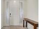 Bright entryway featuring a decorative front door, side lights, and a stylish wooden console table at 7889 Penrose Pl, Wildwood, FL 34785