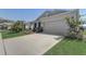 Charming home with attached garage, stone accents, manicured lawn, and tasteful landscaping at 7889 Penrose Pl, Wildwood, FL 34785